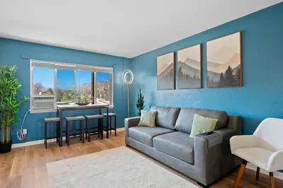 a living room with a couch and a table at 10 min Red Rocks & FAMILY FRIENDLY & 7min to I70 & STR-25-0008 in Golden