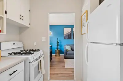 a kitchen with a stove and a white refrigerator at 10 min Red Rocks & FAMILY FRIENDLY & 7min to I70 & STR-25-0008 in Golden