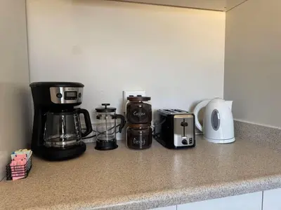 a kitchen counter with a coffeemaker and a coffee maker at 10 min Red Rocks & FAMILY FRIENDLY & 7min to I70 & STR-25-0008 in Golden