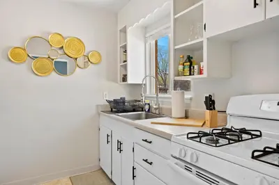a white kitchen with a sink and a stove at 10 min Red Rocks & FAMILY FRIENDLY & 7min to I70 & STR-25-0008 in Golden