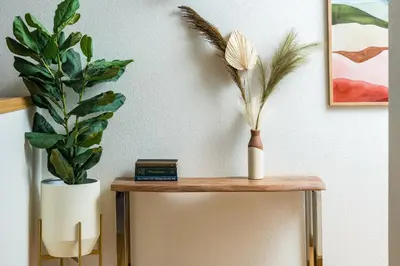 a table with a vase and a plant on it at 5 Bedroom Whole Home with Mountain Views in Evergreen