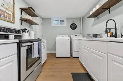 a kitchen with white appliances and white cabinets at 5Bed, 2Bath, 2 Kitchens, Home Office, Pet-Friendly in Denver