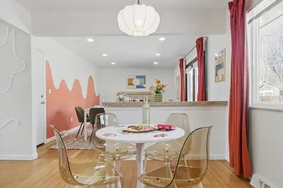 a dining room with a white table and chairs at Spacious 4BD - Backyard BBQ, Fire Pit & Mini Golf in Arvada