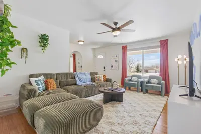 a living room with two couches and a tv at Spacious 4BD - Backyard BBQ, Fire Pit & Mini Golf in Arvada