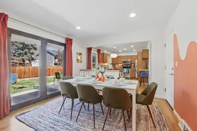 a dining room and kitchen with a table and chairs at Spacious 4BD - Backyard BBQ, Fire Pit & Mini Golf in Arvada
