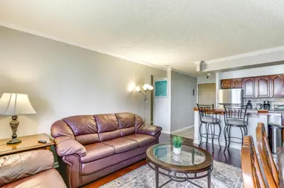 a living room with a couch and a table at Less Than 1 Mi to Downtown Denver Condo with Pool Access! in Denver