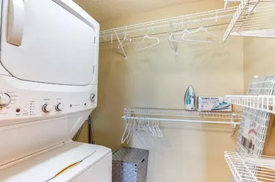 a laundry room with a white refrigerator at Less Than 1 Mi to Downtown Denver Condo with Pool Access! in Denver