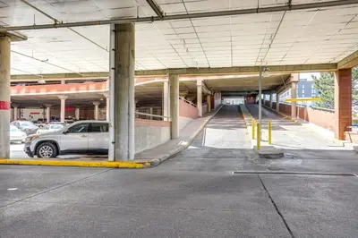 a parking lot with a car parked in a parking garage at Less Than 1 Mi to Downtown Denver Condo with Pool Access! in Denver