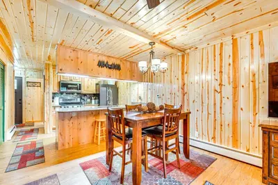 a wooden kitchen with a wooden table and chairs at 1 Mi to Rocky Mtn Natl Park Estes Park Townhome in Estes Park