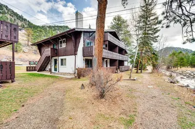 a house with a pole in front of it at 1 Mi to Rocky Mtn Natl Park Estes Park Townhome in Estes Park