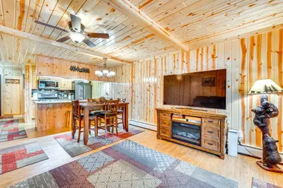 a kitchen and dining room with a table and a television at 1 Mi to Rocky Mtn Natl Park Estes Park Townhome in Estes Park