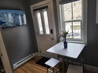 a room with a white table with a vase of flowers at Historic 4 bedroom Victorian Home in Downtown Georgetown in Georgetown