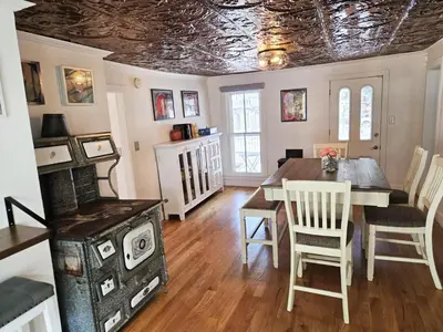 a dining room with a table and chairs and a ceiling at Historic 4 bedroom Victorian Home in Downtown Georgetown in Georgetown