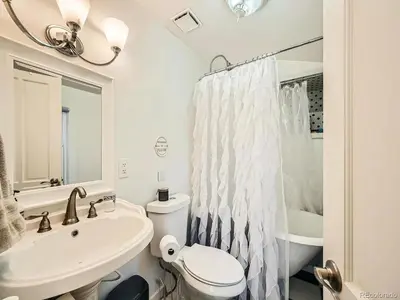 a white bathroom with a sink and a toilet at Victorian Dream! Charming Mountain View Home by Downtown in Georgetown