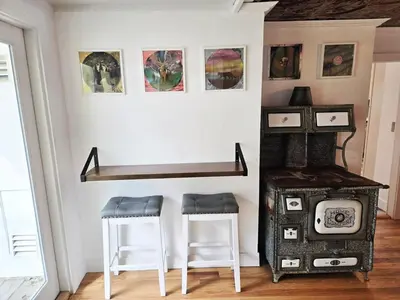 a room with two stools and a stove at Victorian Dream! Charming Mountain View Home by Downtown in Georgetown