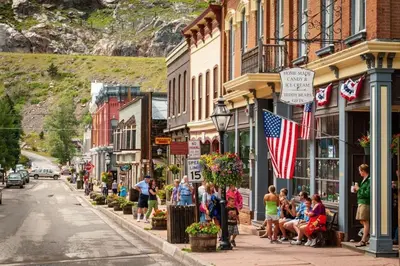 a group of people walking down a street in a town at Charming Downtown Apartment in Victorian Home with Mountain Views in Georgetown