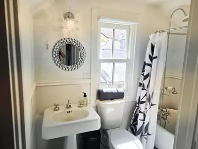 a bathroom with a sink and a toilet and a mirror at Charming Downtown Apartment in Victorian Home with Mountain Views in Georgetown