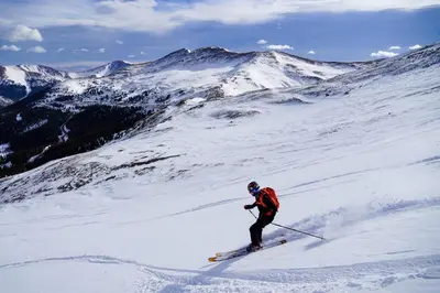 a person is skiing down a snow covered mountain at Charming Downtown Apartment in Victorian Home with Mountain Views in Georgetown