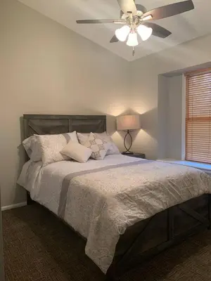 a bedroom with a large bed with a ceiling fan at Cozy Home and Tidy Monthly Weekly Deals in Arvada