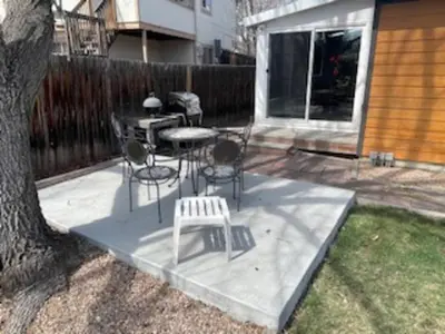 a patio with a table and chairs and a tree at Cozy Home and Tidy Monthly Weekly Deals in Arvada