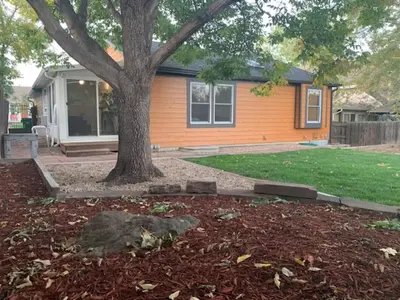 a house with a tree in the front yard at Cozy Home and Tidy Monthly Weekly Deals in Arvada