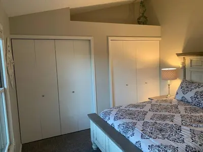 a bedroom with a bed and white cabinets at Cozy Home and Tidy Monthly Weekly Deals in Arvada