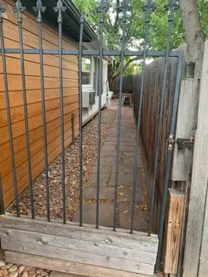 a gate to a house with a wooden fence at Cozy Home and Tidy Monthly Weekly Deals in Arvada