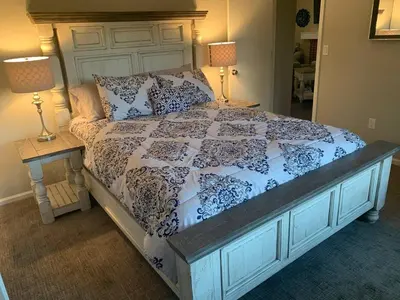 a bed with a blue and white comforter and two lamps at Cozy Home and Tidy Monthly Weekly Deals in Arvada