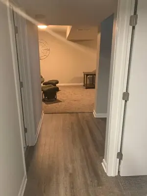 a hallway with a room with a couch and a table at Cozy Home and Tidy Monthly Weekly Deals in Arvada