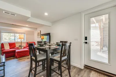 a dining room with a table and chairs and a couch at 14 Mi to Pearl Street Mall Erie Getaway in Erie