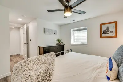 a bedroom with a bed and a ceiling fan at 14 Mi to Pearl Street Mall Erie Getaway in Erie