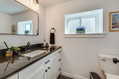 a bathroom with a sink and a mirror at 14 Mi to Pearl Street Mall Erie Getaway in Erie