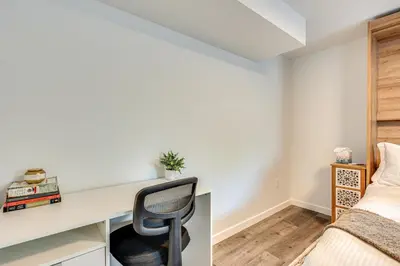 a bedroom with a desk with a chair next to a bed at 14 Mi to Pearl Street Mall Erie Getaway in Erie