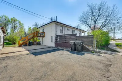 a white house with a fence and a driveway at 14 Mi to Pearl Street Mall Erie Getaway in Erie