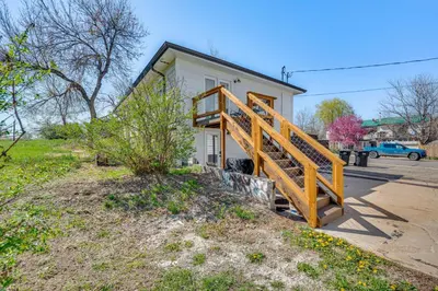a house with a wooden staircase in front of it at 14 Mi to Pearl Street Mall Erie Getaway in Erie