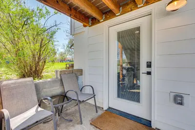 a porch with two chairs and a door with a window at 14 Mi to Pearl Street Mall Erie Getaway in Erie