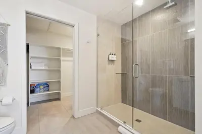 a bathroom with a glass shower with a toilet at 2880(U306): Sunlit Escape in Denver