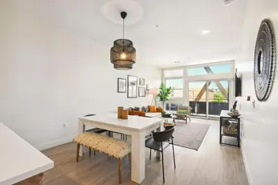 a dining room with a white table and chairs at 2880(U306): Sunlit Escape in Denver