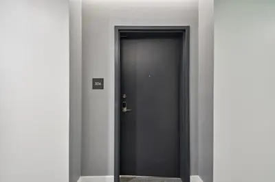 a corridor with a black door in a building at 2880(U306): Sunlit Escape in Denver