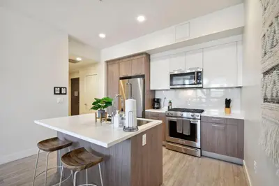 a kitchen with wooden cabinets and a white counter top at 2880(U306): Sunlit Escape in Denver