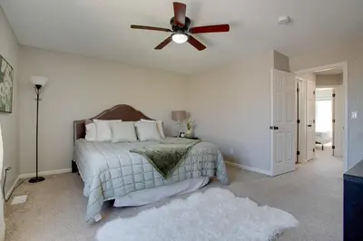 a bedroom with a bed with a ceiling fan at La Casita with Private Yard 17 Mi to Dtwn Denver in Henderson