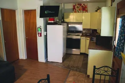 a kitchen with a white refrigerator and a stove at Rural Cabin Rental in Gorgeous Poudre Canyon near Fort Collins, Colorado in Fort Collins