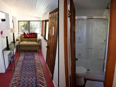 a hallway of a bathroom with a toilet and a shower at Romantic Hideaway Cottage on Clear Creek in Georgetown, Colorado in Georgetown