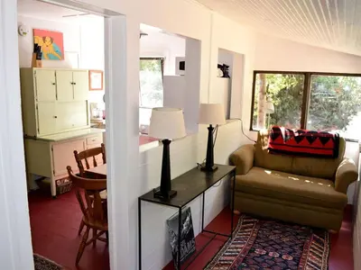a living room with a couch and a table at Romantic Hideaway Cottage on Clear Creek in Georgetown, Colorado in Georgetown