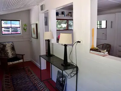 a living room with a table with a lamp on it at Romantic Hideaway Cottage on Clear Creek in Georgetown, Colorado in Georgetown