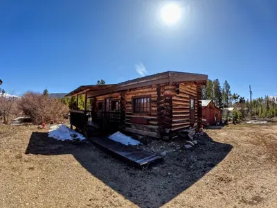 a log cabin with a slide in a field at Arrowhead in Grand Lake