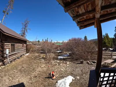 a view of the yard from the porch of a cabin at Arrowhead in Grand Lake