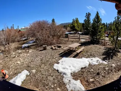 a park with a bench and snow on the ground at Arrowhead in Grand Lake
