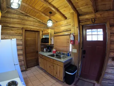 a kitchen in a log cabin with a sink at Arrowhead in Grand Lake