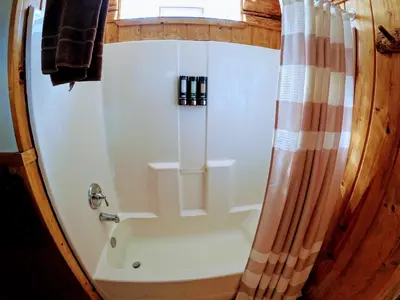 a bathroom with a shower with a shower curtain at Arrowhead in Grand Lake